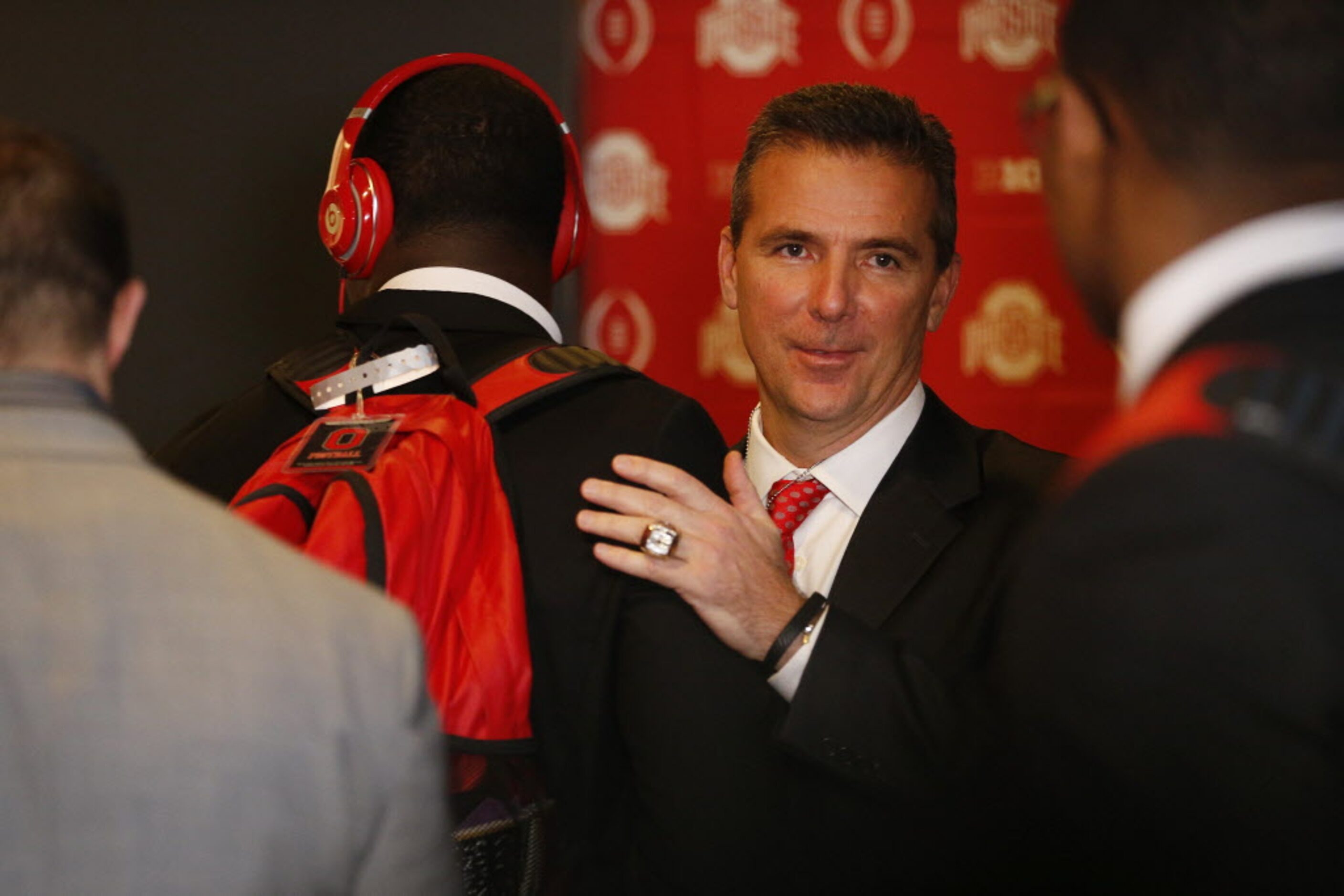 Ohio State Buckeyes head coach Urban Meyer welcomes his players to the locker room before...