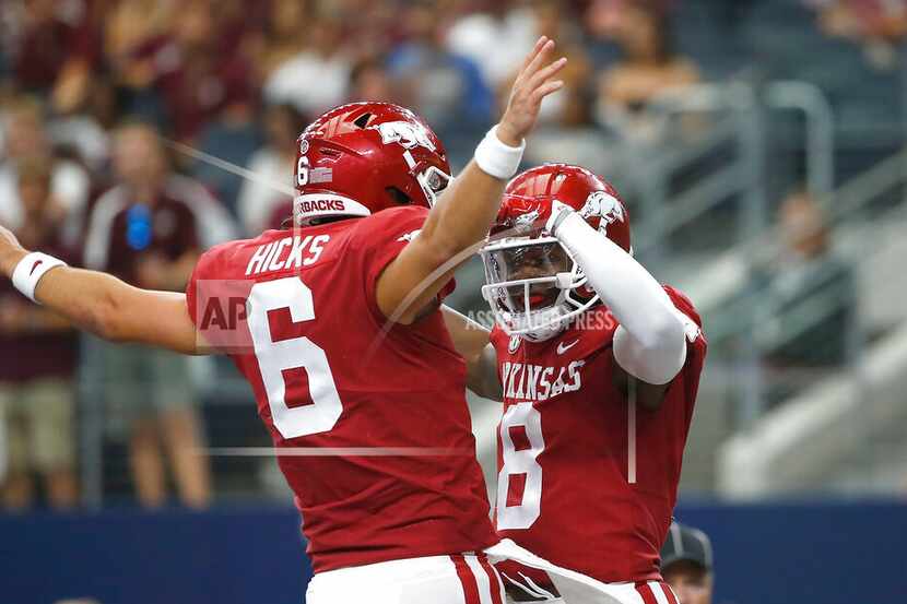 Arkansas quarterback Ben Hicks (6) and wide receiver Mike Woods (8) celebrate a touchdown...