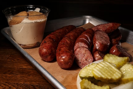 True Texas BBQ’s sausage and banana pudding dessert are photographed here in 2022, when the...