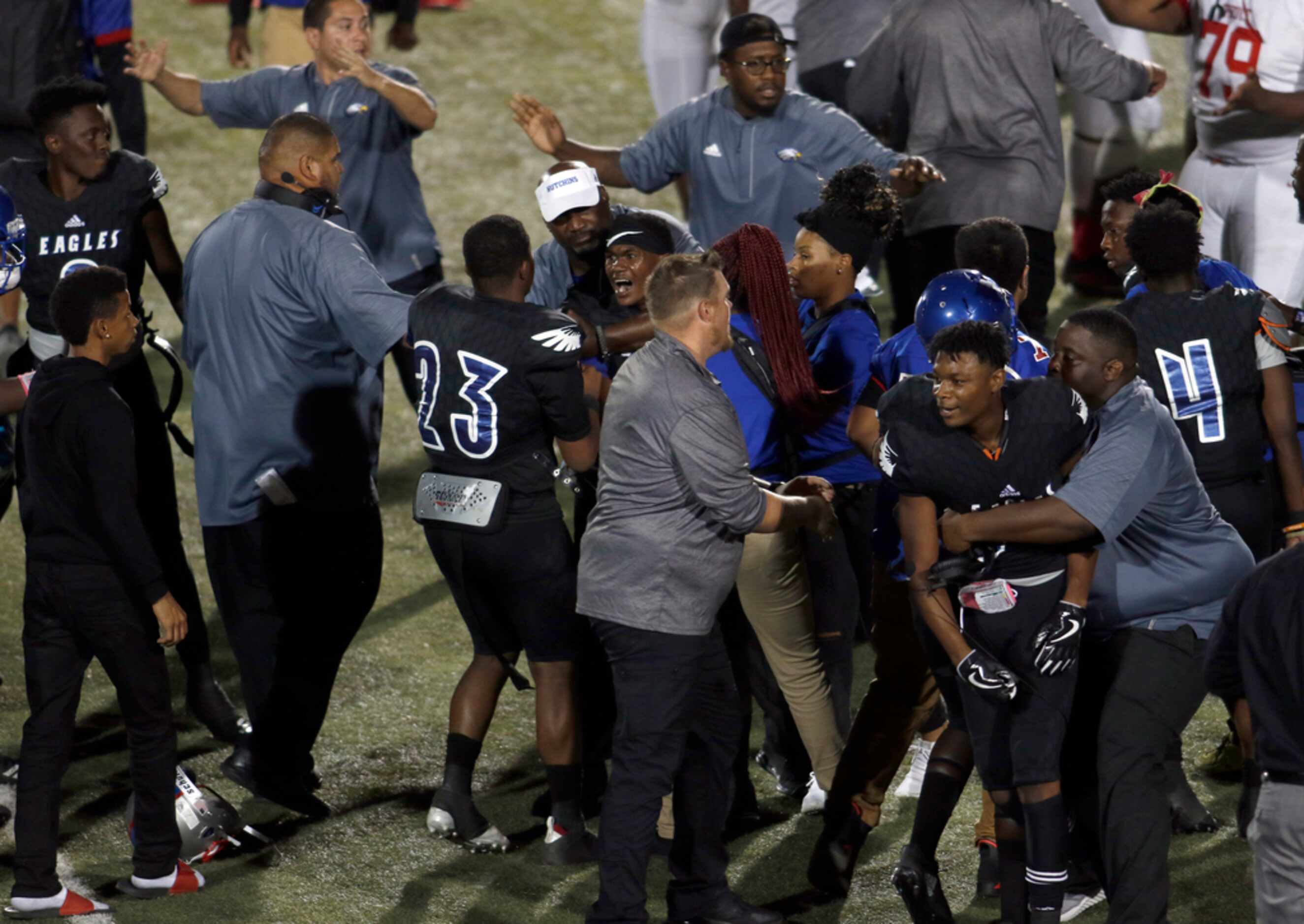 Emotions were raw as coaches work to calm Wilmer-Hutchins players at midfield following...