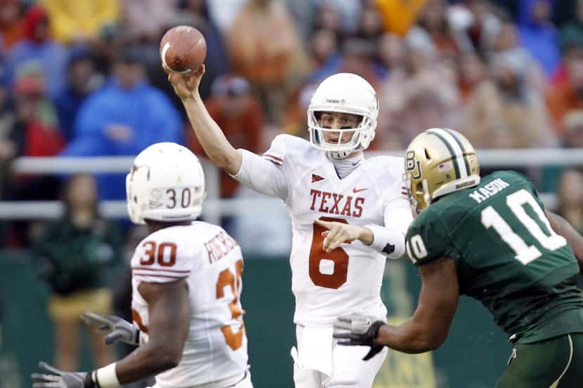 Texas quarterback Case McCoy (6) passes the ball to Texas fullback Ryan Roberson (30) in a...