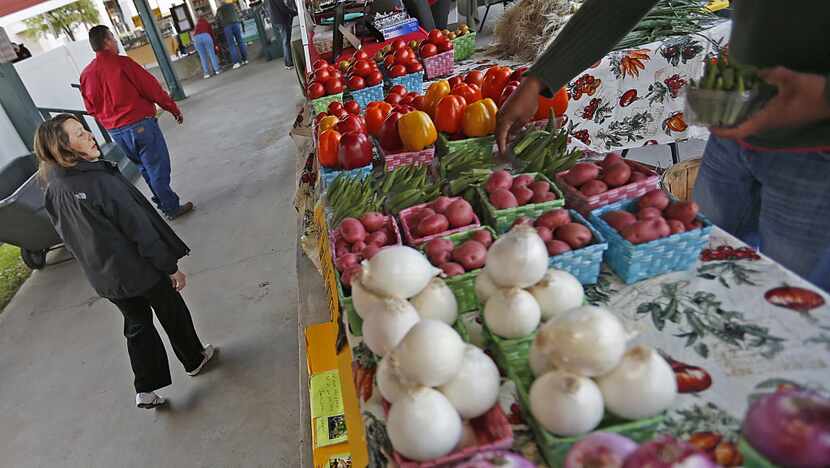 Kathy Neumuller (left) of Plano, a vendor at the the Collin County Farmers Market in Plano,...