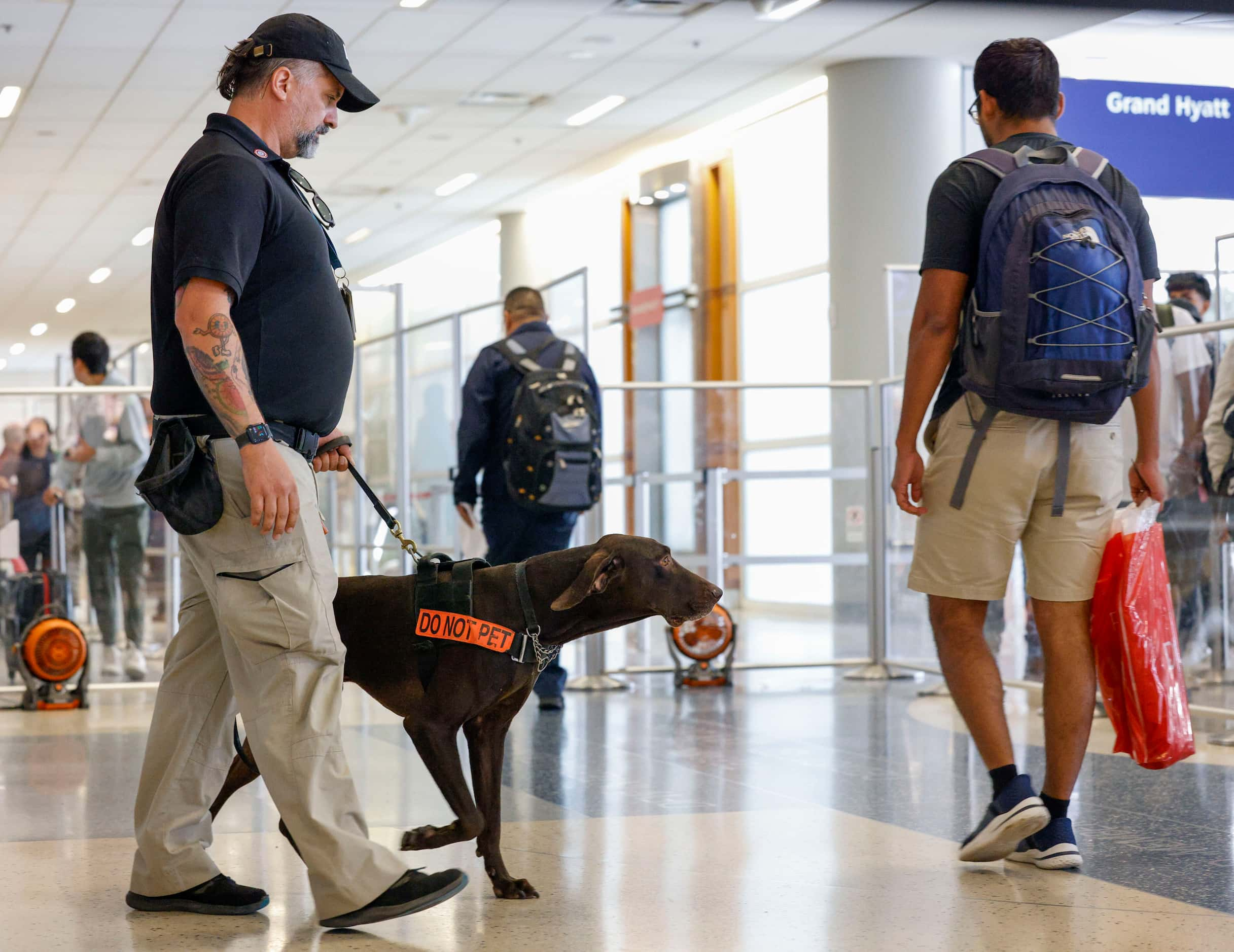 Explosive K-9 detection handler Kevin Farren walks explosive detection K-9 Dusan, a...