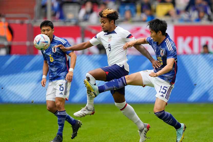Japan's Daichi Kamada, right, and United States Weston McKennie challenge for the ball...