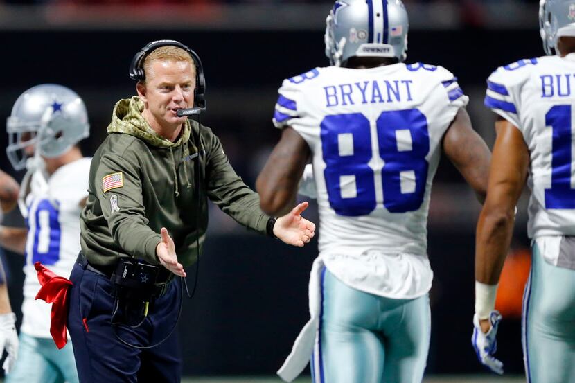 Dallas Cowboys head coach Jason Garrett greets the offense, including wide receiver Dez...