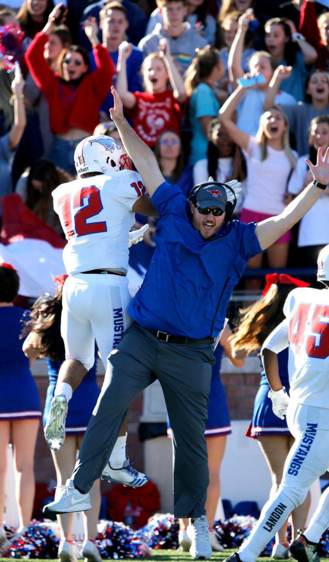 Pearce High School half backs and tight ends coach Brandon Grayson (right) high fives Pearce...