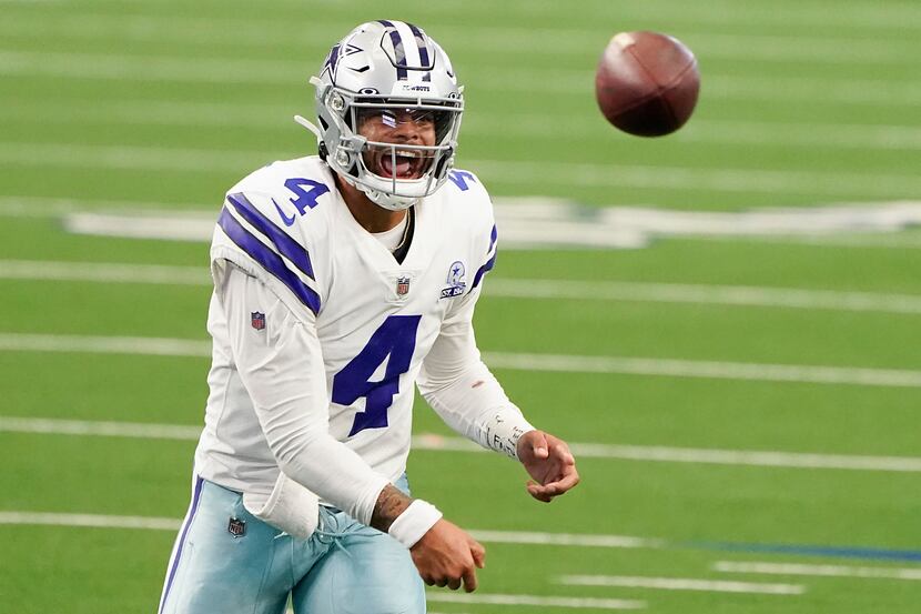 Cowboys quarterback Dak Prescott attempts a pass during the second quarter of a game against...