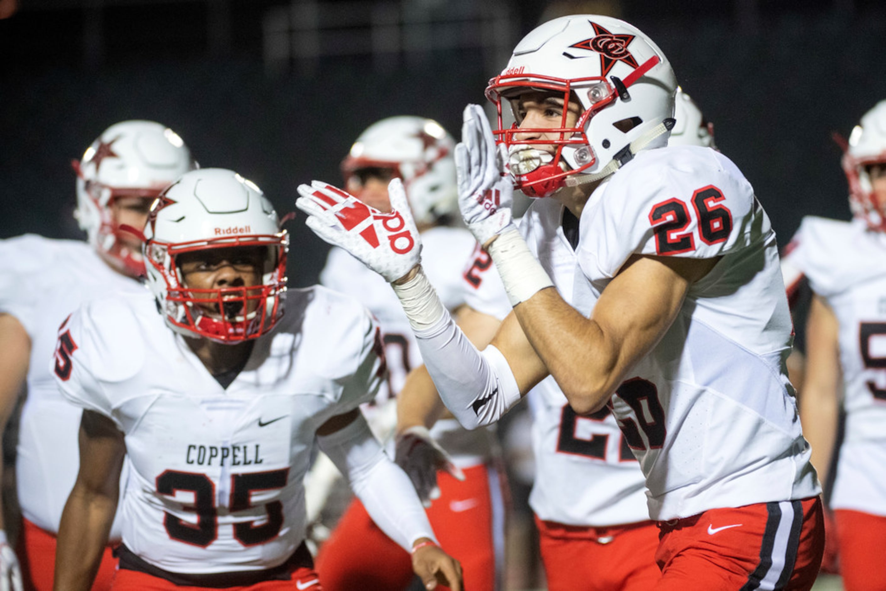 Coppell senior defensive backs Noah Snelson (26) and Omar Hasan (35) celebrate a fumble that...