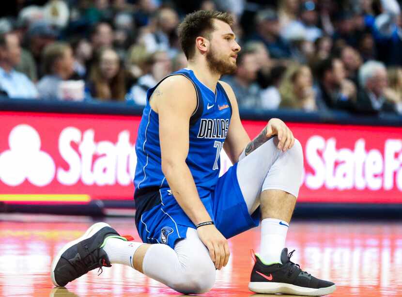 Dallas Mavericks forward Luka Doncic (77) collapse to the floor after getting a ball stolen...