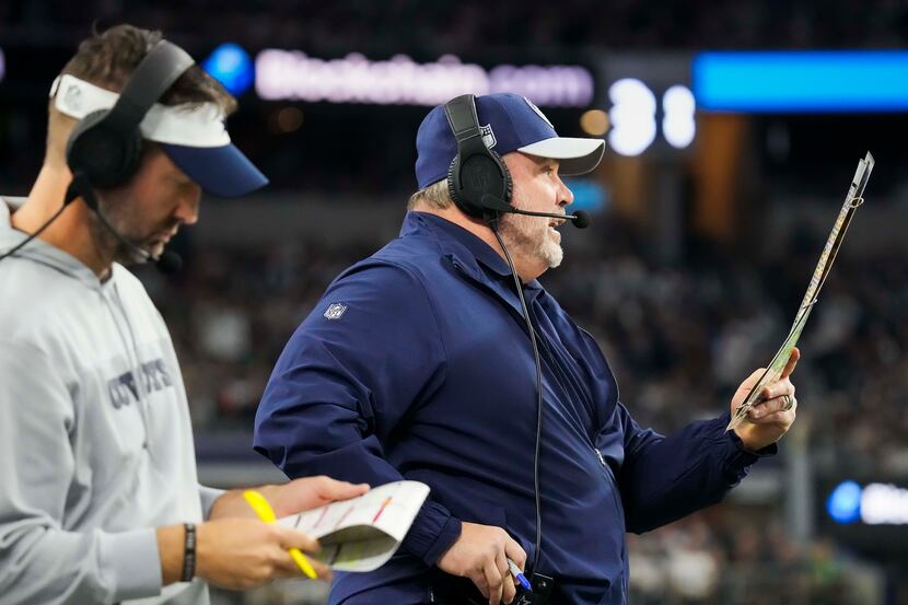 Dallas Cowboys head coach Mike McCarthy calls in a play alongside offensive coordinator...