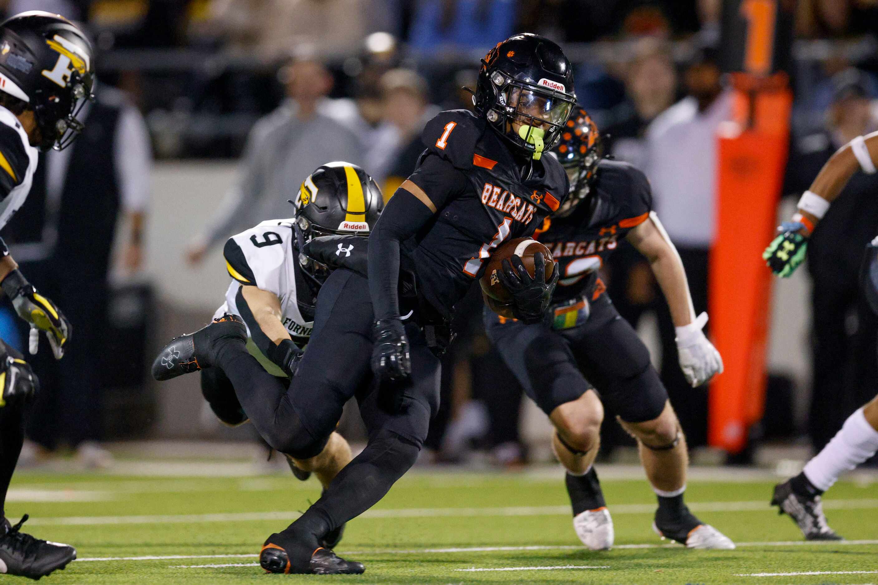 Aledo running back Hawk Patrick-Daniels (1) runs through a tackle attempt from Forney...