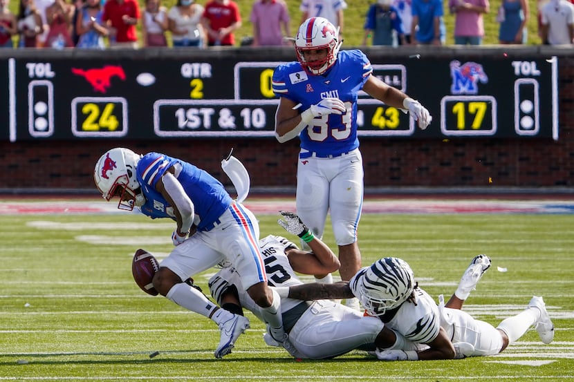 SMU wide receiver Reggie Roberson Jr. (8) turns the ball over with a fumble after a hit from...