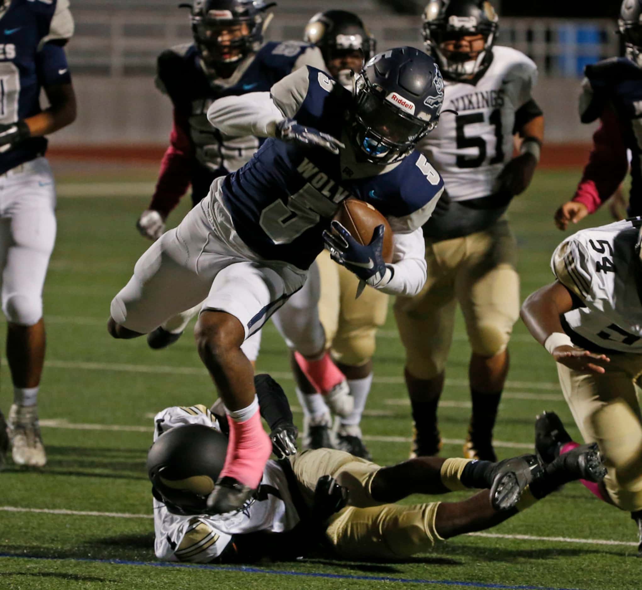 Ranchview's Chris Cotton (5) is tackled by PInksont's Bronya Todd (1) during the first half...