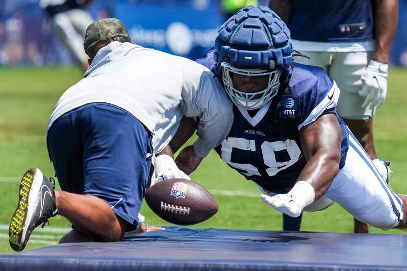 Dallas Cowboys defensive tackle Mazi Smith (58) knocks the ball away from defensive line...
