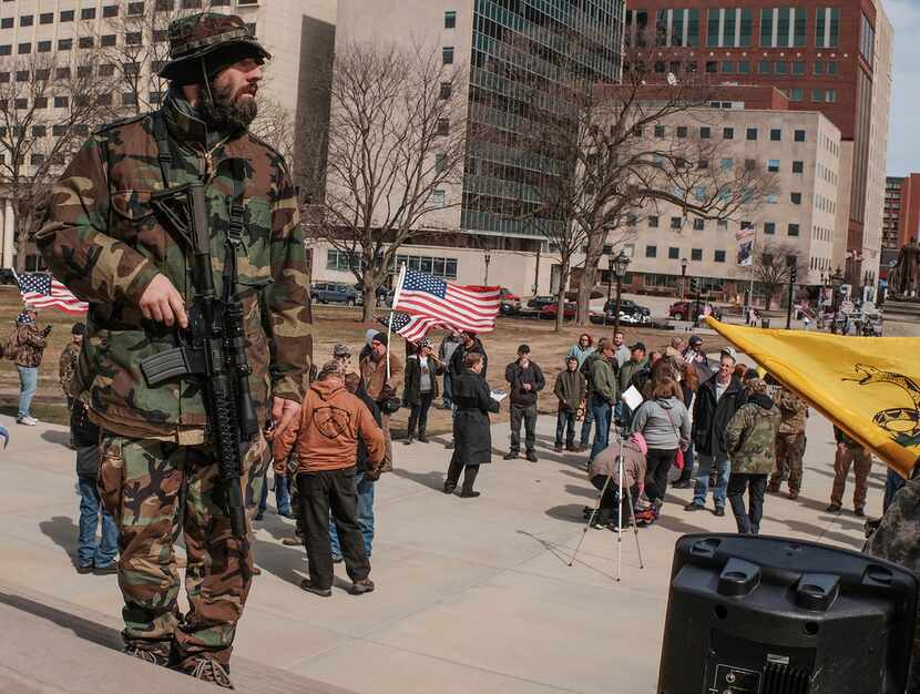A man openly carries a weapon during a pro-Second Amendment rally at the State Capitol in...