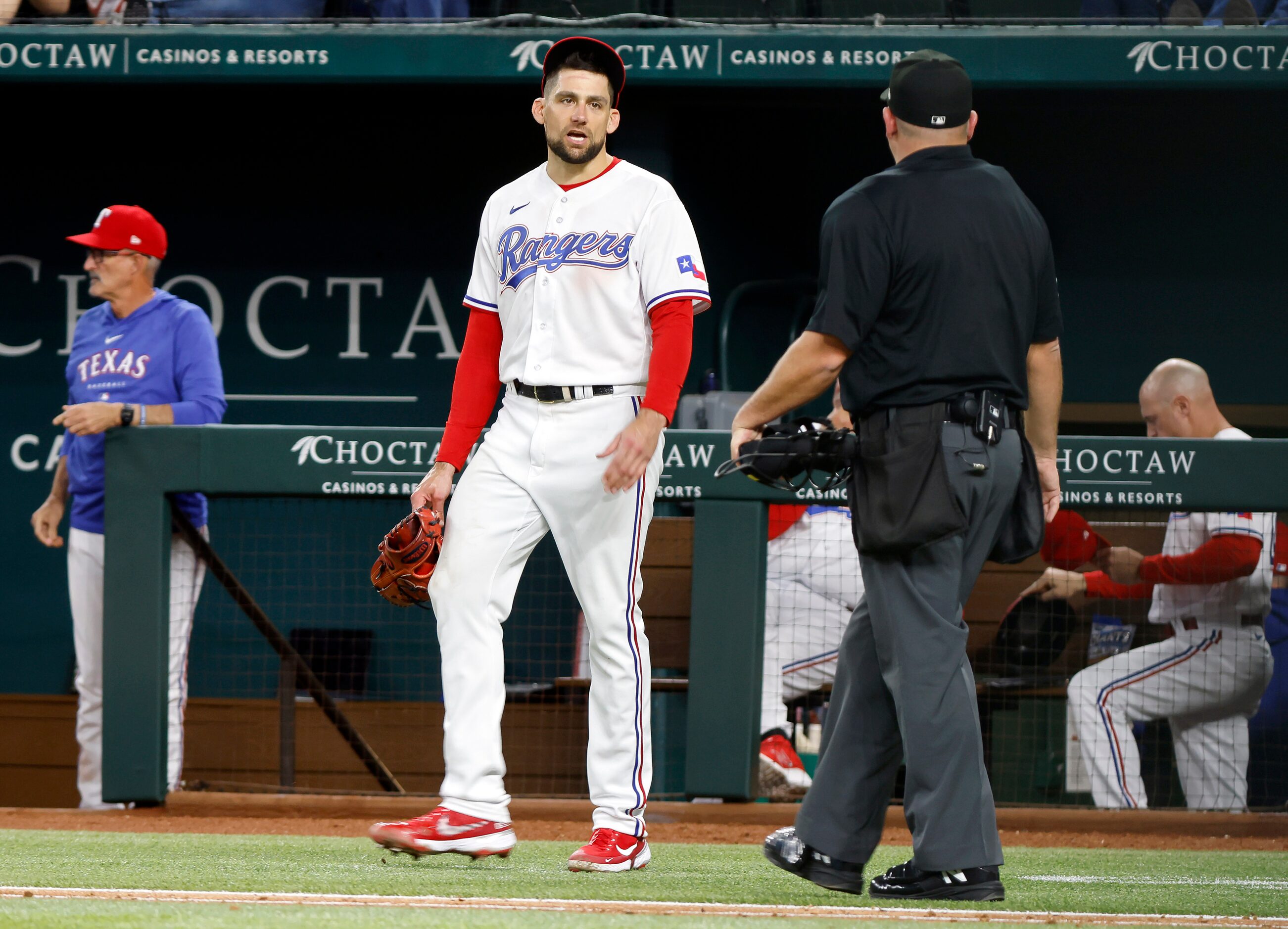 Texas Rangers starting pitcher Nathan Eovaldi (17) speaks with home plate umpire Jeremy...