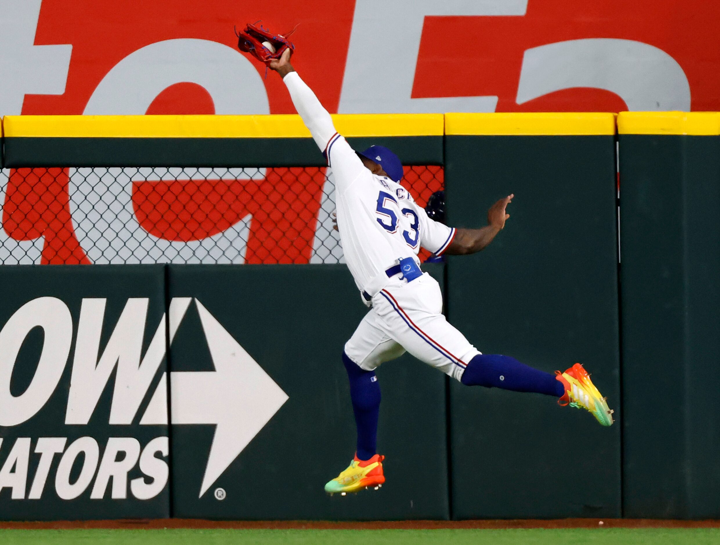 Texas Rangers right fielder Adolis Garcia (53) makes a leaping catch to get Houston Astros...