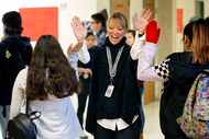 Thomas Jefferson High School principal Sandi Massey greets her students with high-fives as...