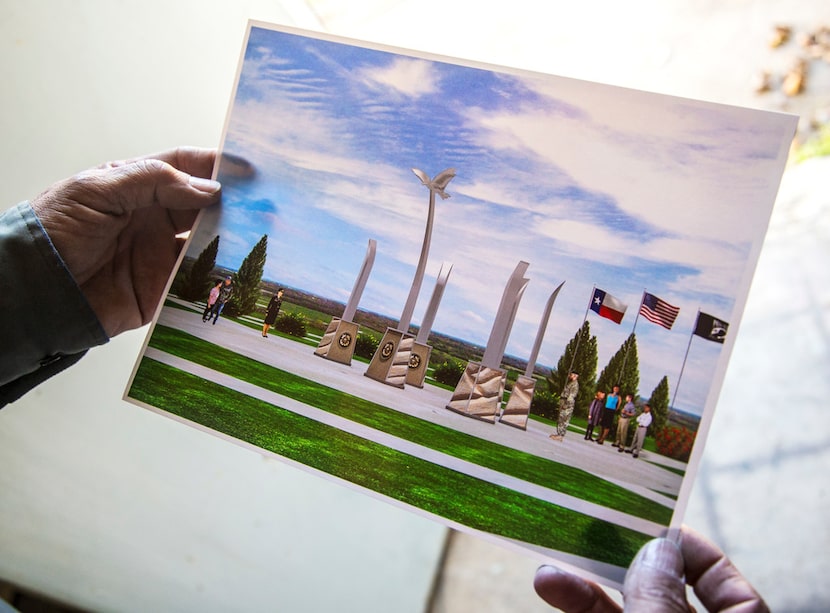 Sculptor Eliseo Garcia holds a photo illustration of the future memorial plaza near the...