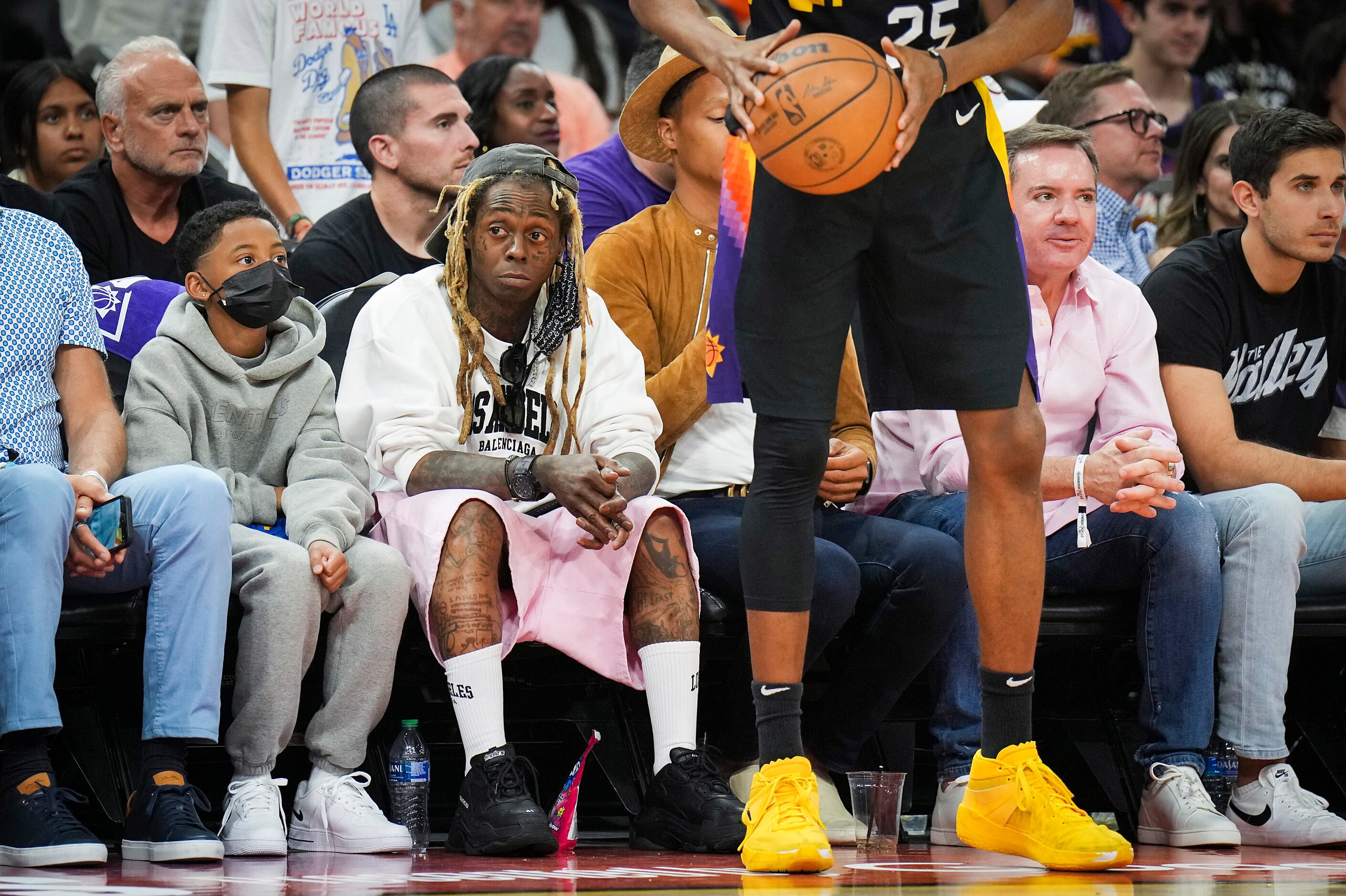 Rapper Lil Wayne watches from courtside during the second quarter in Game 7 of an NBA second...