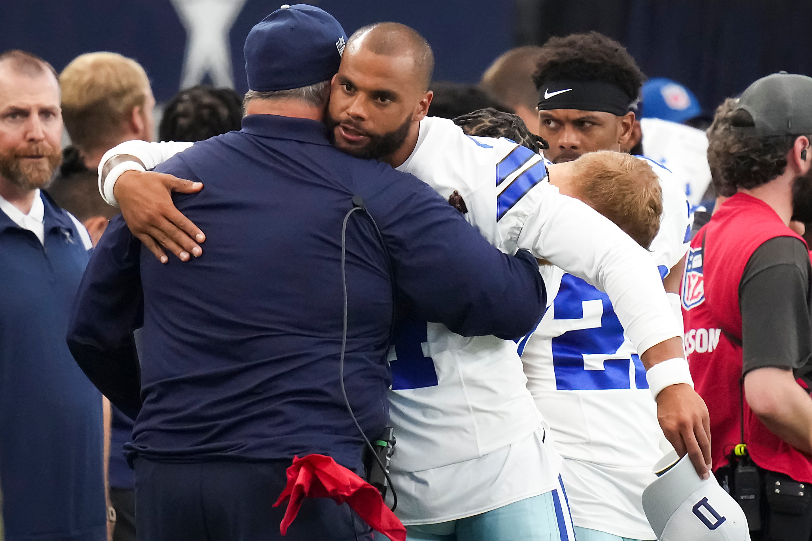 Dallas Cowboys quarterback Dak Prescott hugs head coach Mike McCarthy before an NFL...