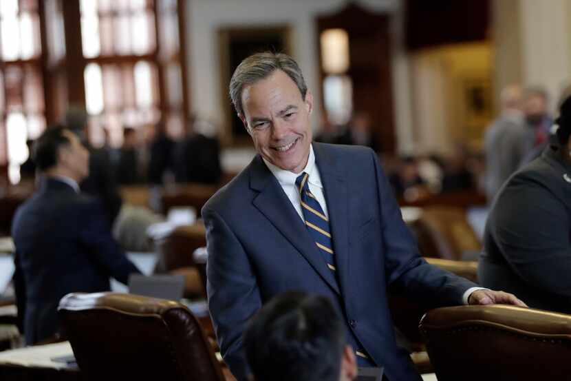  House Speaker Joe Straus, R-San Antonio, talks with fellow lawmakers on the House floor....