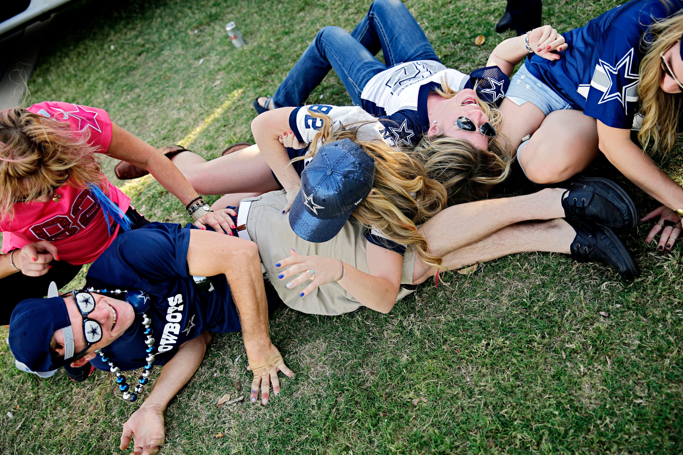 Brian Garland (left) ends up on the floor as he dances with friends before the Dallas...