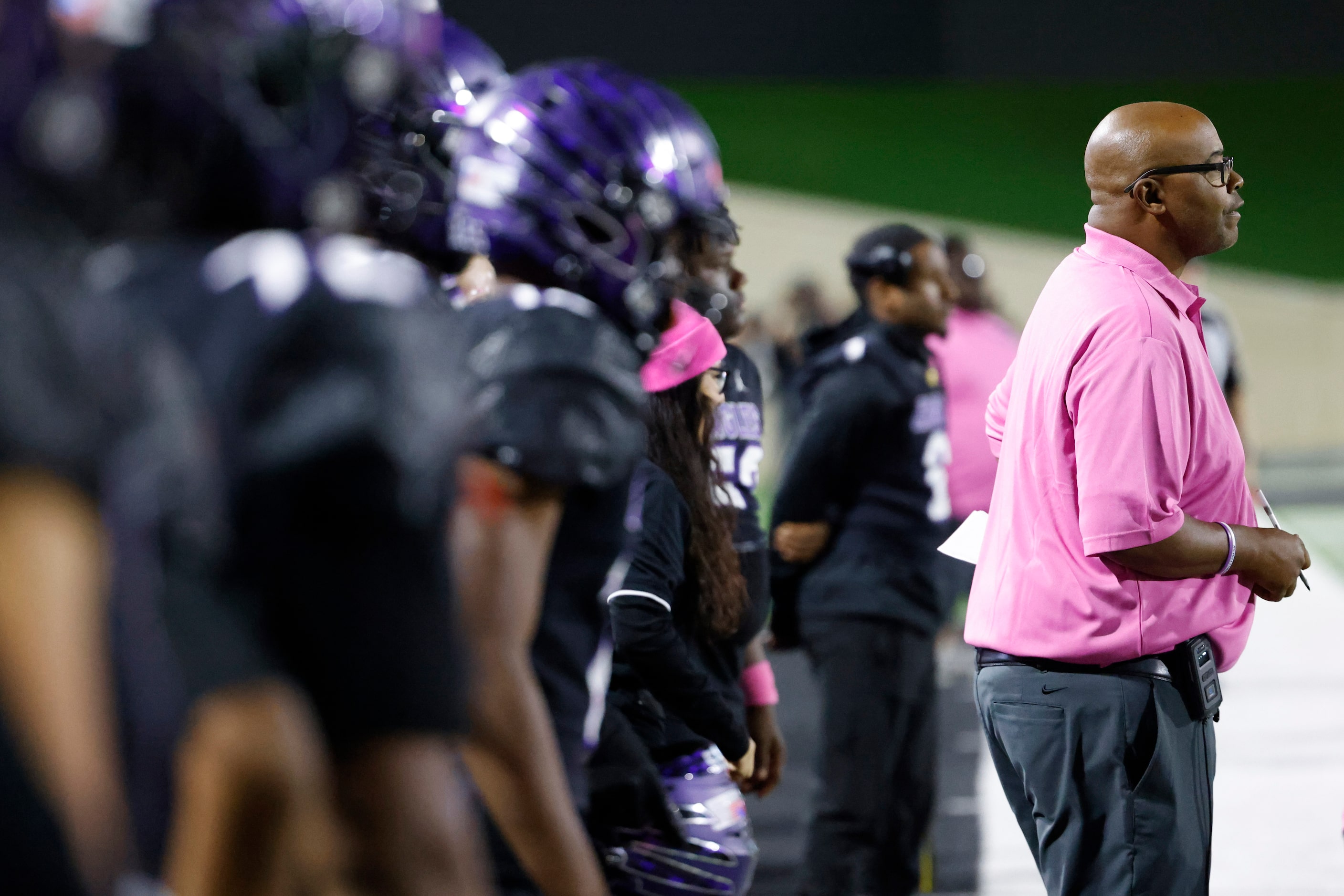 Crowley High head coach Carlos Lynn remains by the sideline against Trinity High during the...