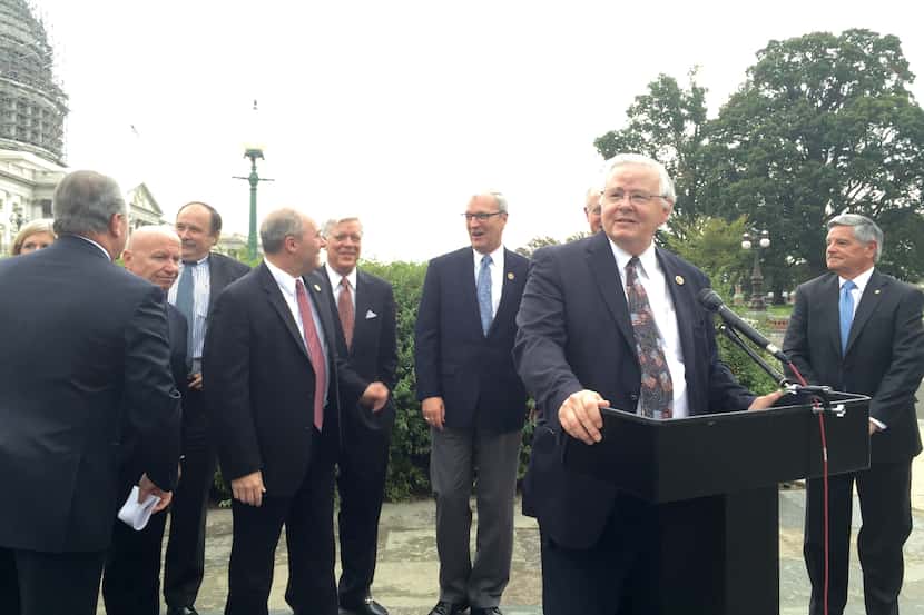  At lectern, Rep. Joe Barton, R-Arlington, speaks at the Capitol shortly after the House of...