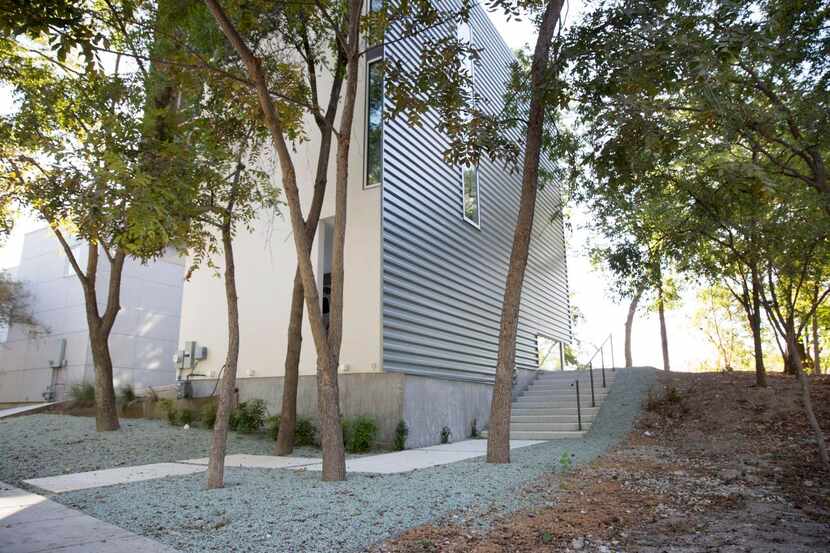 
The vertical design echoes the tall, thin trees on the lot. The entrance is at the back...