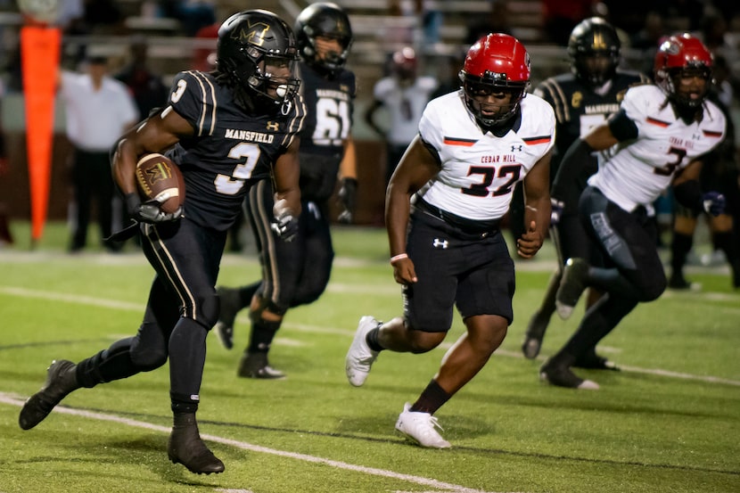 Mansfield junior James Johnson (3) rushes up the field to gain yardage during a District...