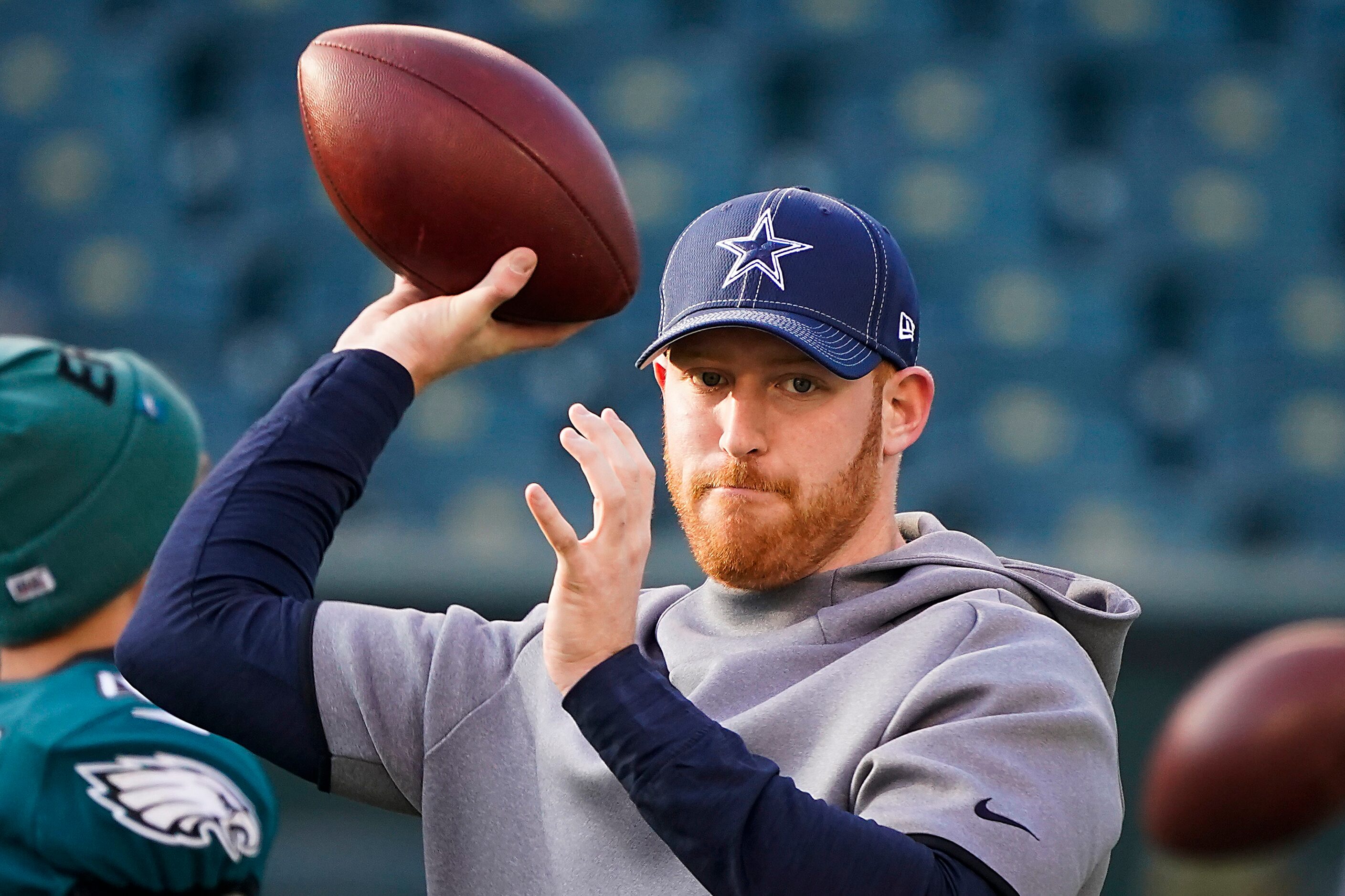 Dallas Cowboys quarterback Cooper Rush warms up before an NFL football game against the...