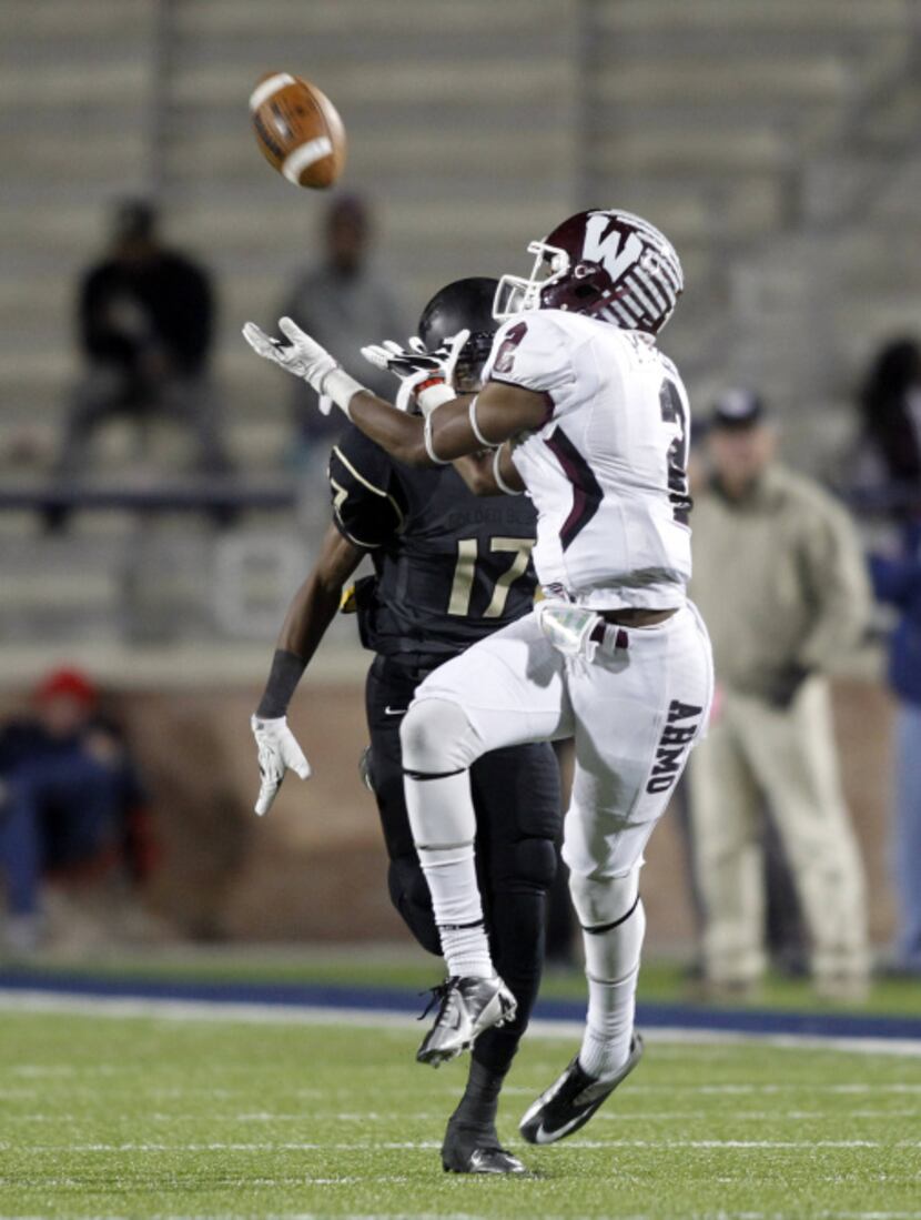 Wylie wide receiver Kameron Kelly (2) hauls in a pass as he is defended by South Oak Cliff...
