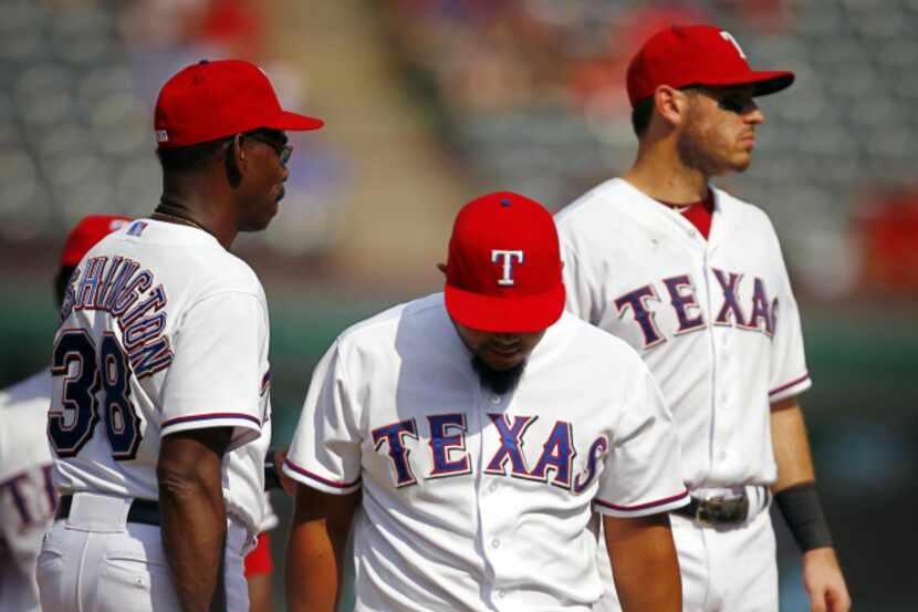 Texas Rangers manager Ron Washington (38) relieves Joe Ortiz (center) during the seventh...