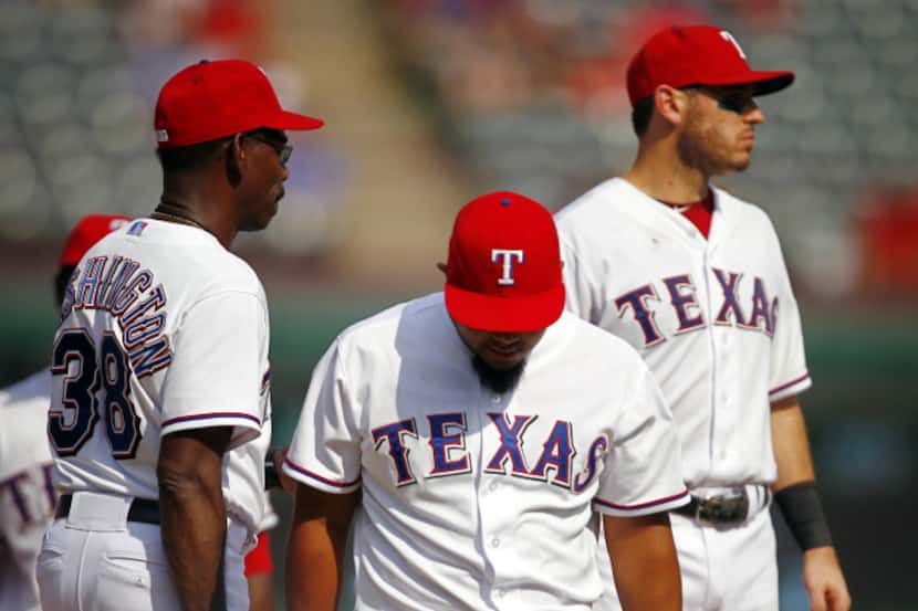 Texas Rangers manager Ron Washington (38) relieves Joe Ortiz (center) during the seventh...