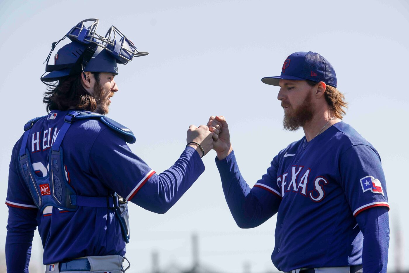 Texas Rangers catcher Jonah Heim, left, and right handed pitcher Jon Gray fist bumps after...