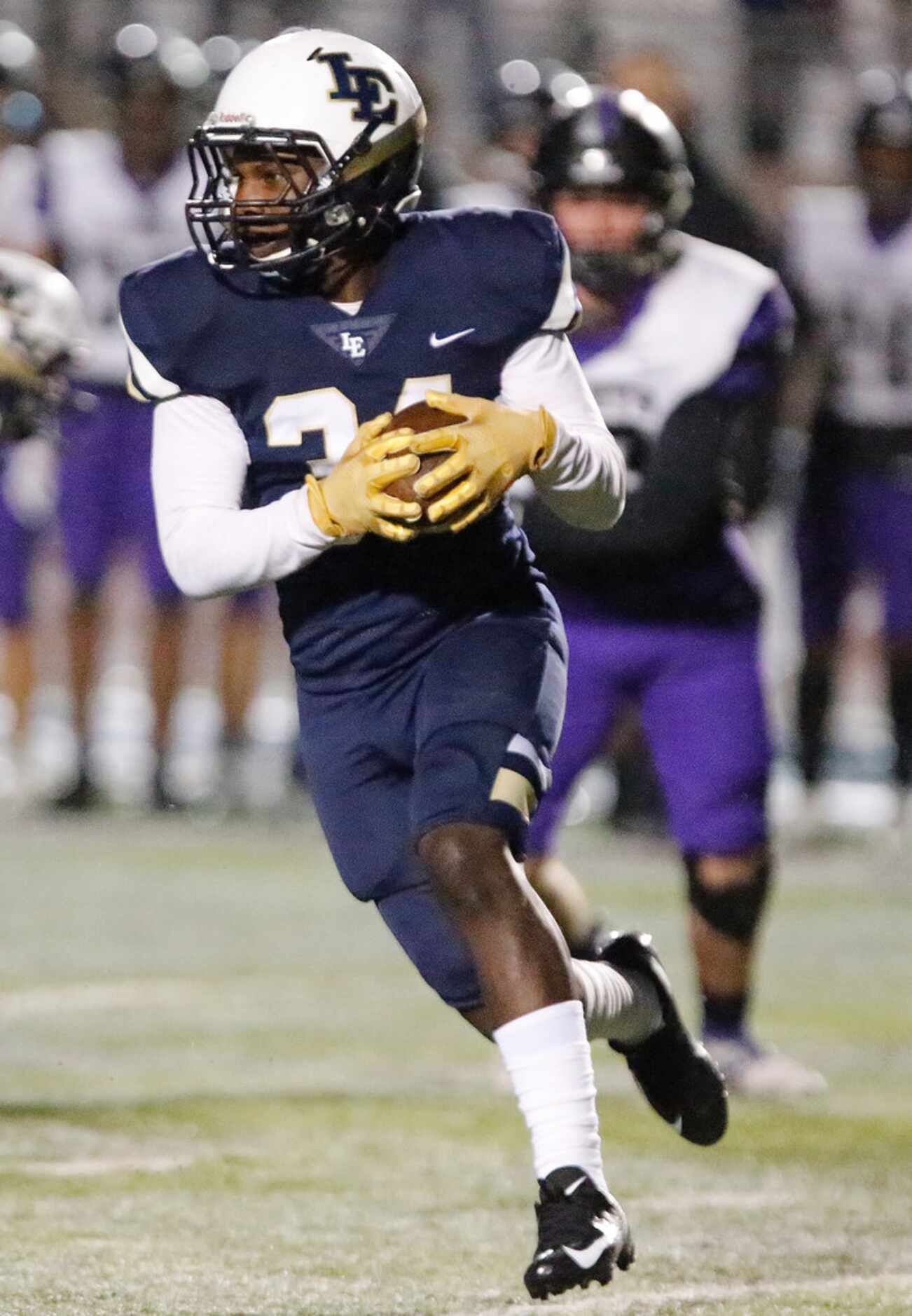 Little Elm High School running back Andrew Stone (34)  carries the football during the first...