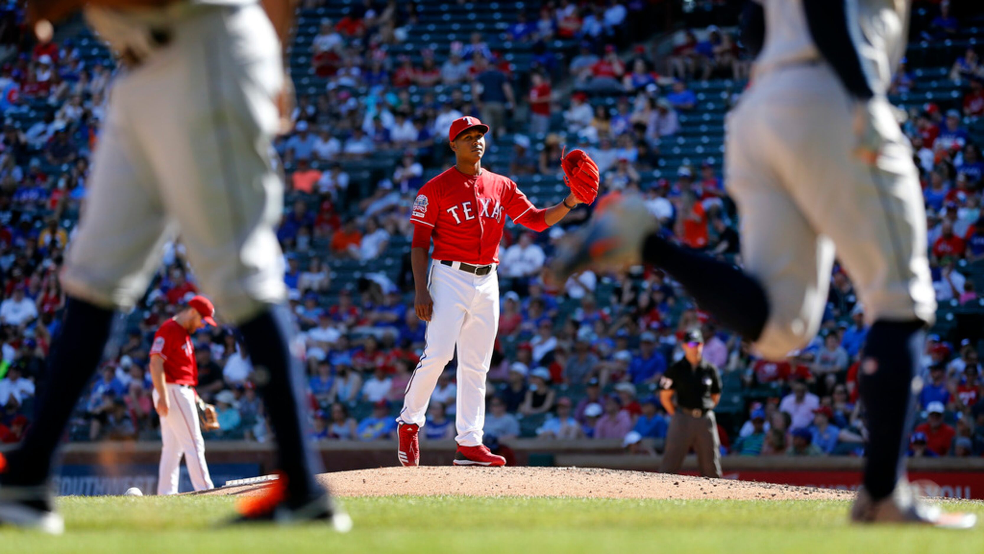 Texas Rangers relief pitcher Jose Leclerc watches Houston Astros batter George Springer...