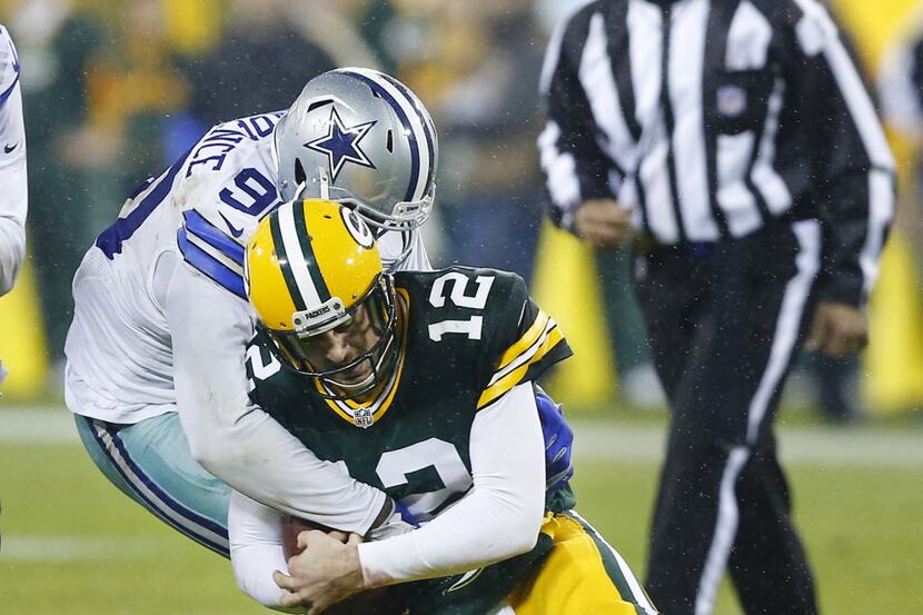 Dallas Cowboys defensive end Demarcus Lawrence (90) wraps up Green Bay Packers quarterback...