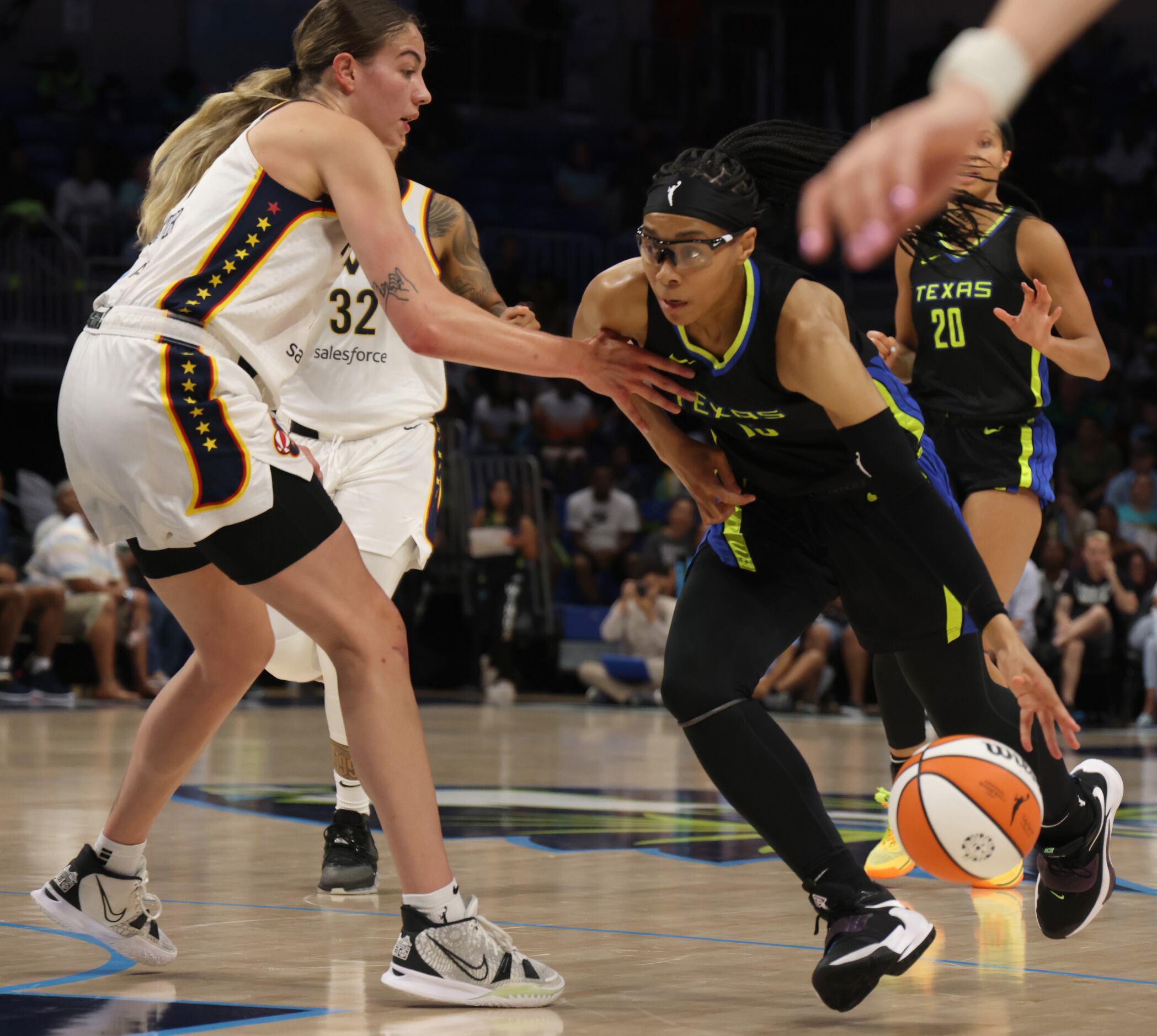 Dallas Wings guard Allisha Gray (15) drives the lane against the defense of Indiana Fever...