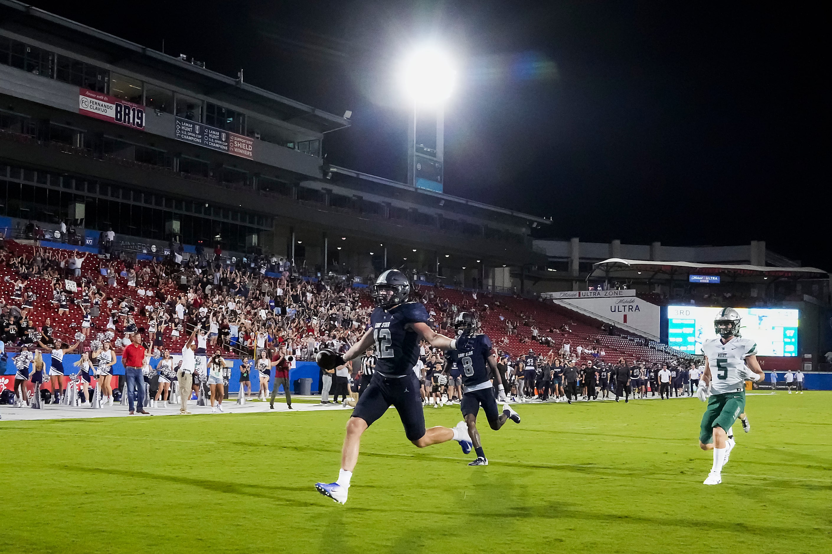 Frisco Lone Star’s Ryder Mix (12) scores past Frisco Reedy’s Cooper Clabo (5) on a 36-yard...