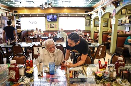 Perla Zamora gives a customer his check at Chaf-In Restaurant in Cleburne.