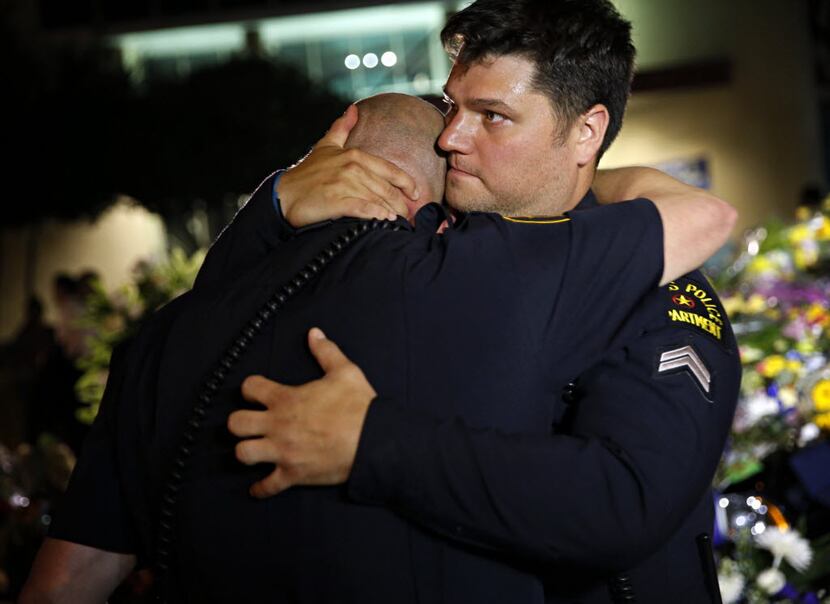 Dallas Police Department officers were overcome with emotion as they visited a memorial in...