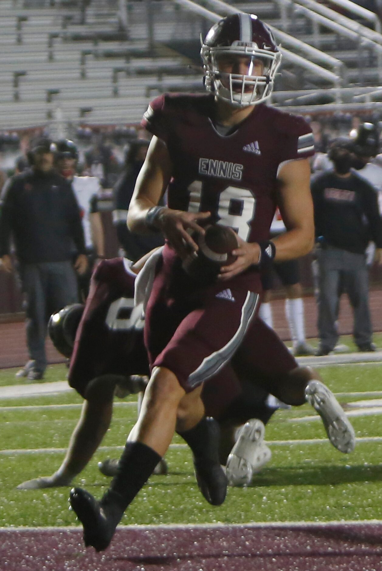 Ennis quarterback Collin Drake (18) rambles into the end zone for a first quarter rushing...