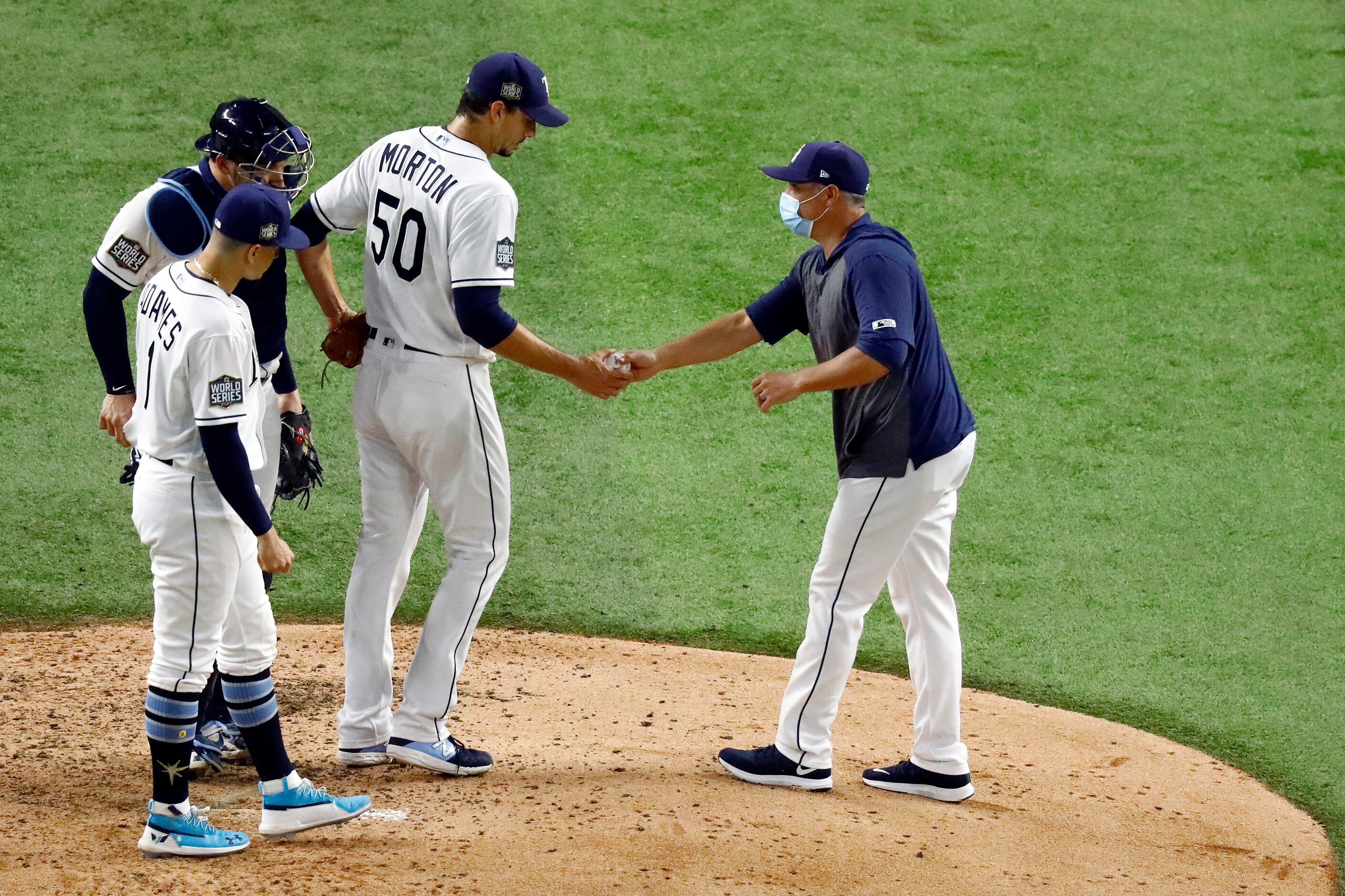 Tampa Bay Rays manager Kevin Cash (right) takes the ball from starting pitcher Charlie...