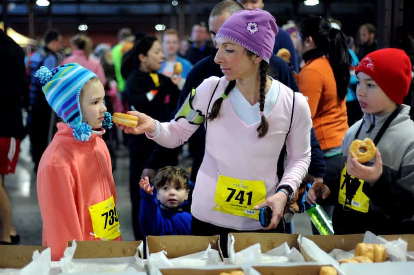 Danielle Fitch feeds a donut to her daughter Eibhlin Steele at the Hypnotic Donut Dash at...