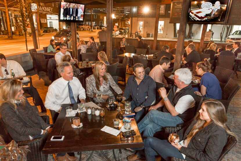 People socialize on the patio at Cliff's Bar & Grill on McKinney Avenue in Dallas, Thursday,...