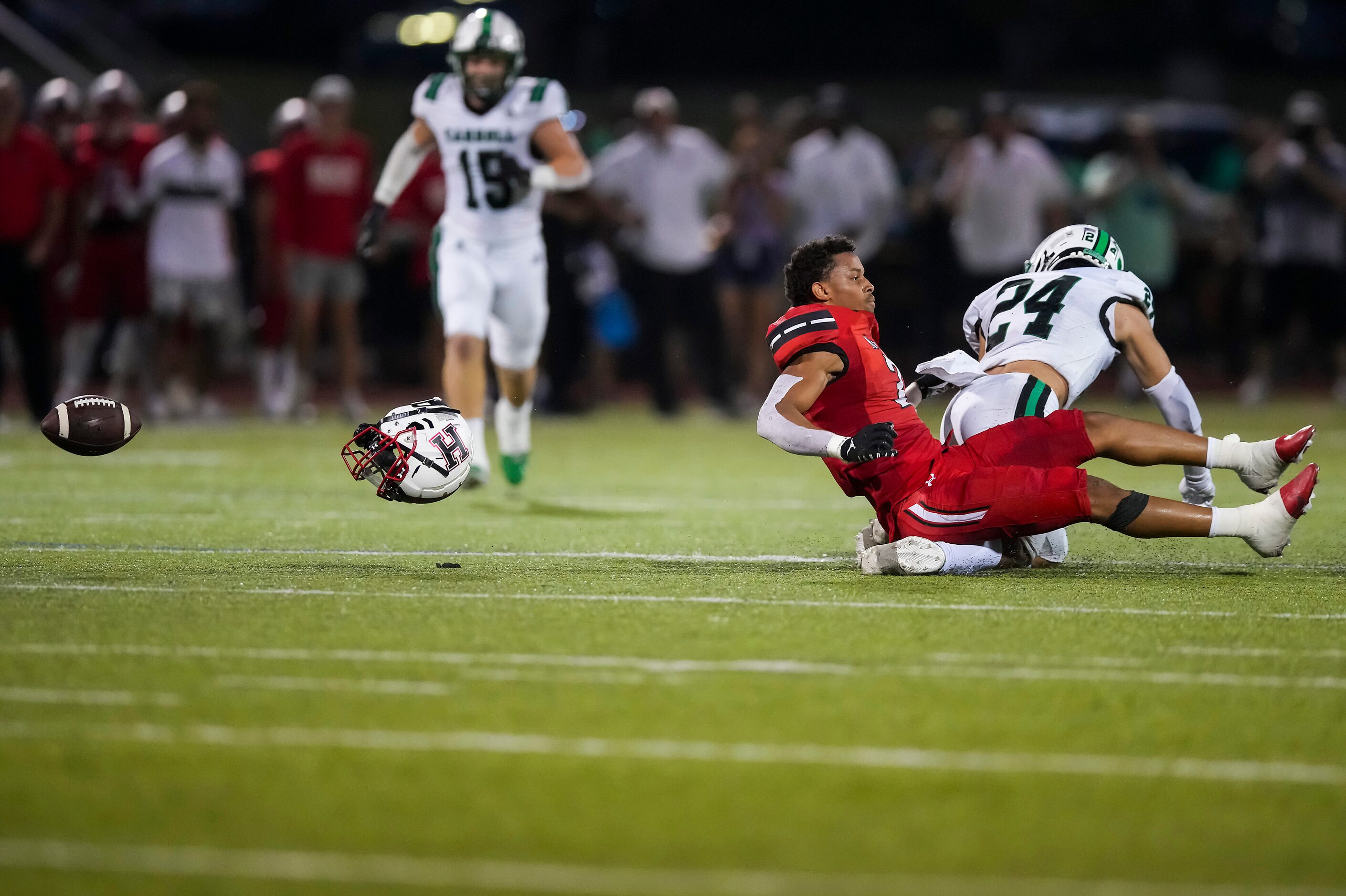 Rockwall-Heath wide receiver Jordan Nabors (2) loses his helmet while the ball flies away as...