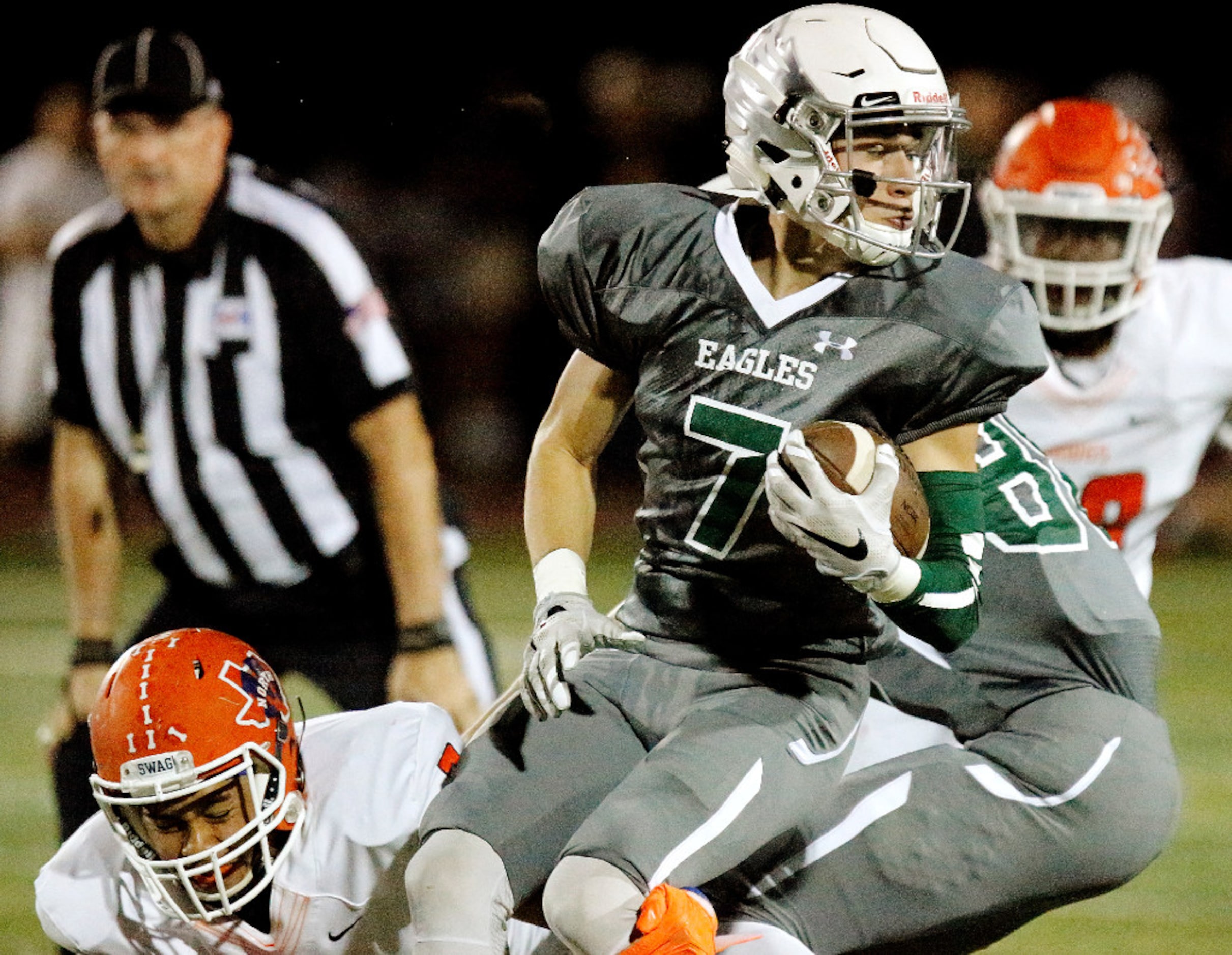 Prosper High School quarterback Austin Lind (7) carries the football during the first half...