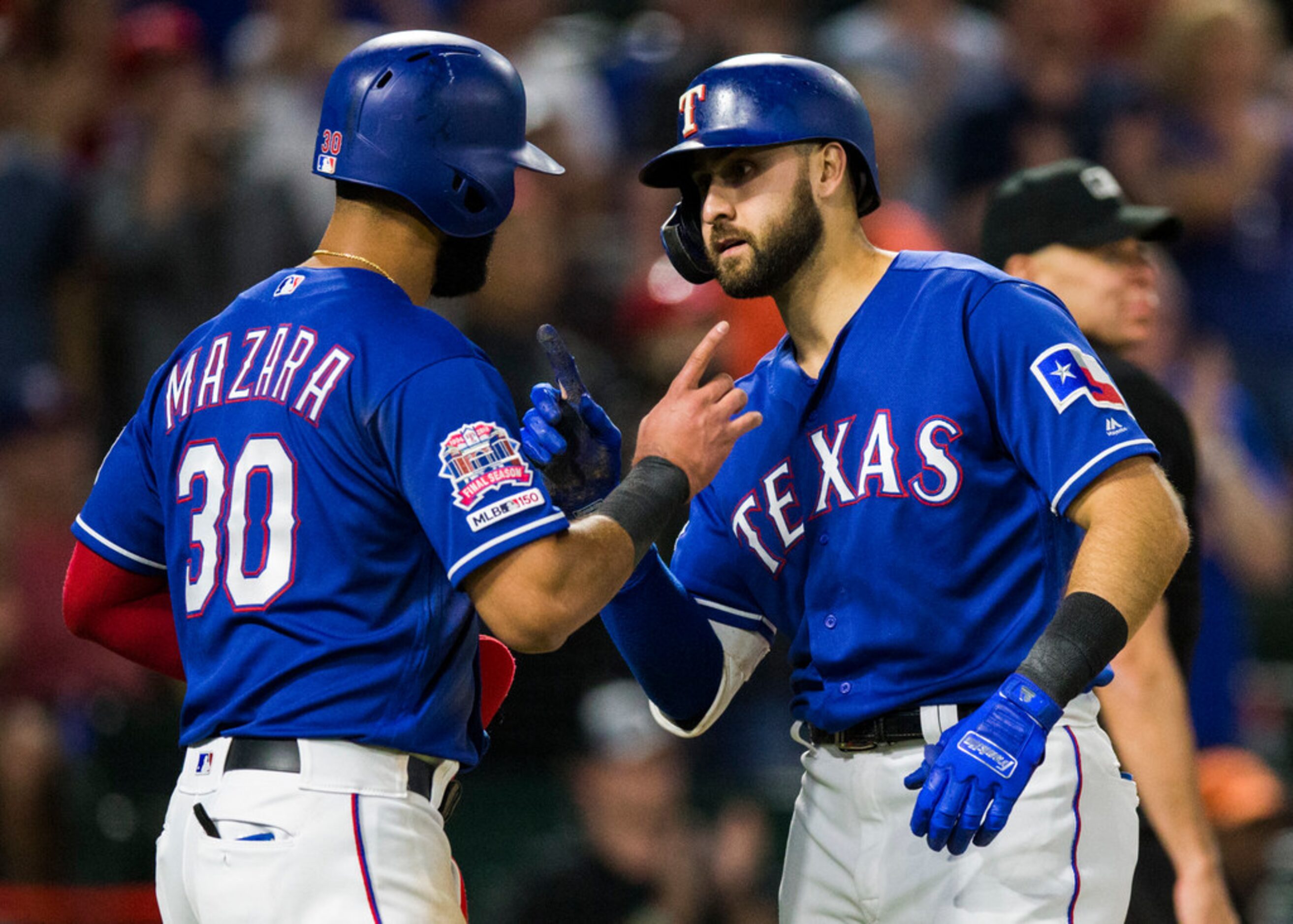 Texas Rangers center fielder Joey Gallo (13) celebrates with right fielder Nomar Mazara (30)...